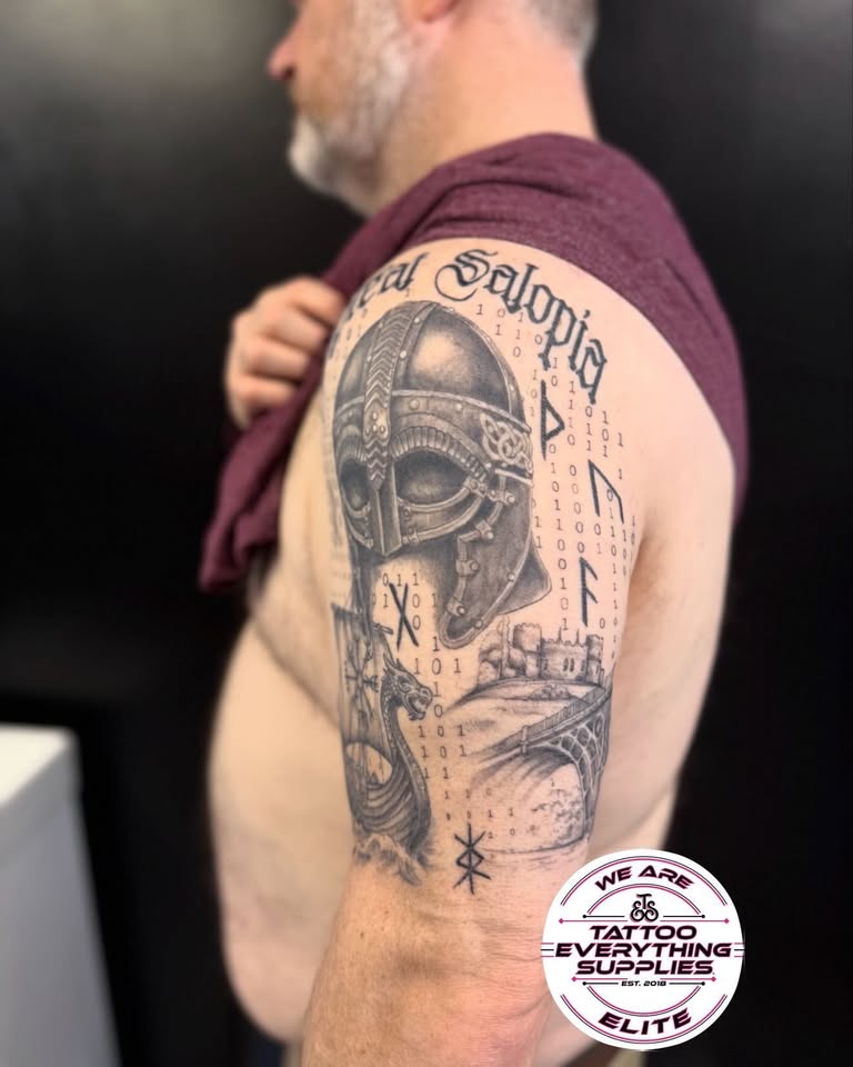 Viking helmet and longship sleeve tattoo, a featured piece by Dorni Appel