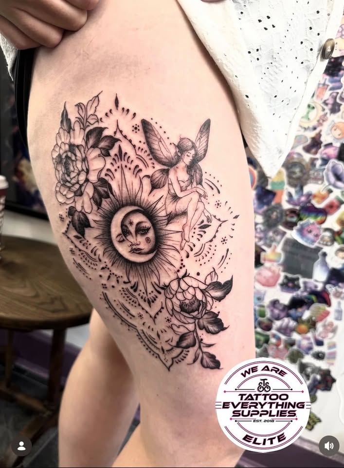 Sun, moon, and fairy thigh tattoo with floral detail